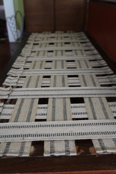 Weaving new webbing on a wooden couch frame